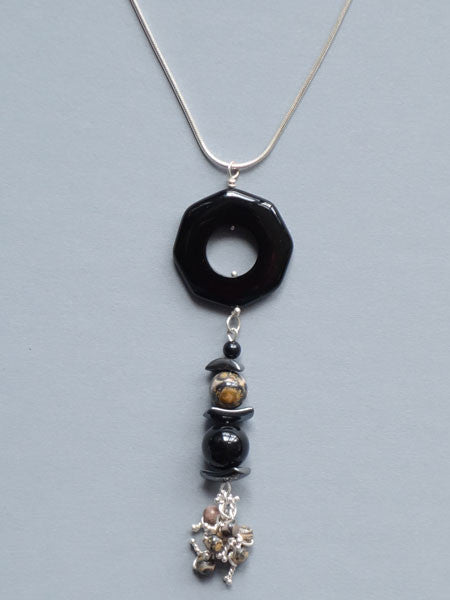 Pendant necklace of black onyx, hematite,  and leopard skin jasper beads. Sterling snake chain included.