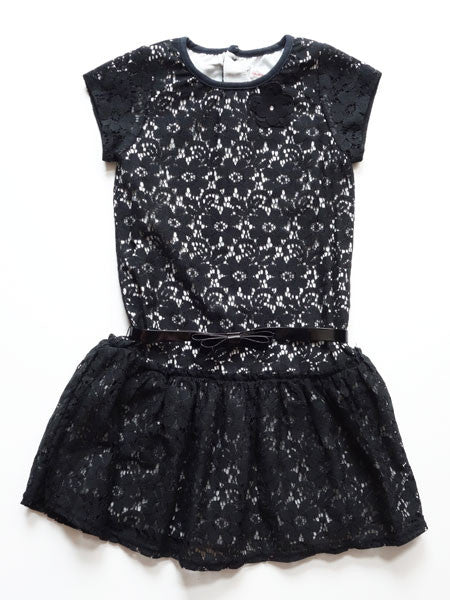 Black lace girls party dress.  Drop waist style with  patent leather belt at natural waist. Short cap sleeves, white lining visible under lace.