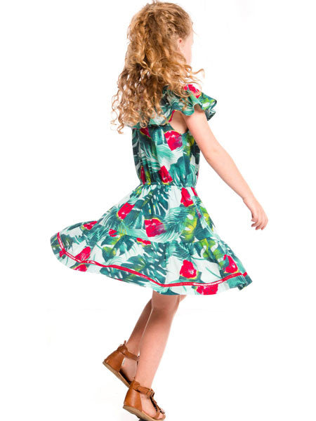 Girl wearing  the watermelon print girls sundress by Deux par Deux. Cold shoulder ruffle neckline with thin straps. Gathered waist with full skirt.