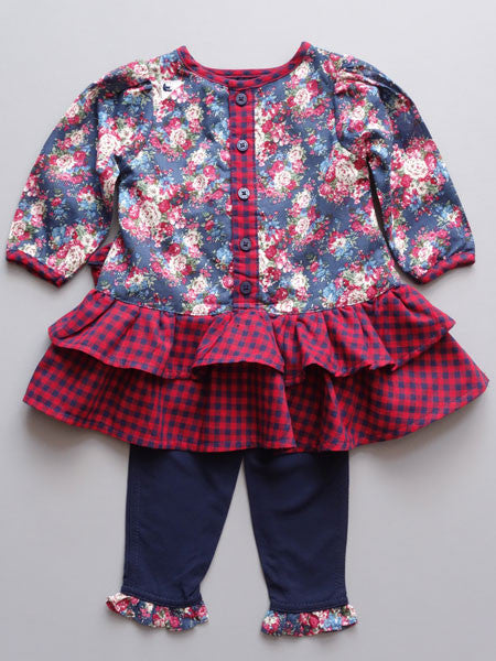Navy floral baby dress with red and blue gingham ruffled skirt, long sleeves. Drop waist style. Navy matching leggings with floral ruffle at hem.