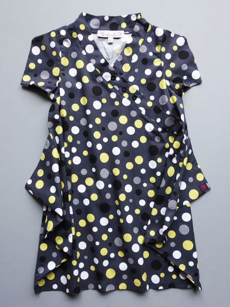 Modern retro styling dot print dress by Kidcuteture. Charcoal with gray, white, yellow and black dots. Short sleeves. Handkerchief hem.