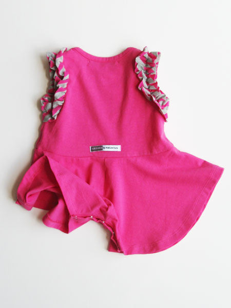 Back view, Baby girls one piece romper skort . Raspberry pink. Sleeveless, with gray and pink striped ruffle trim on armholes and down the front to the waist.
