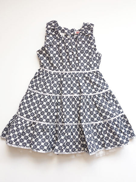 Slate gray and white abstract clover print little girls party dress. Tiered. Metallic ribbon and thread accents. Sleeveless.