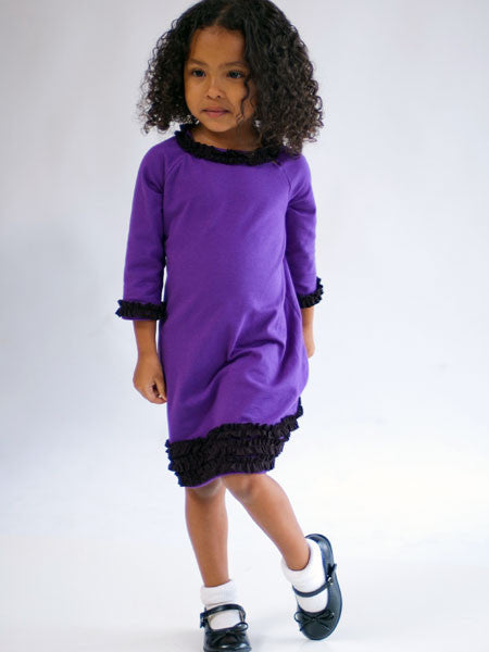 Purple medium weight jersey knit dress, long sleeves. Black ruffle trim on collar, sleeves, and hem line.
