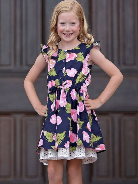 Navy and pink print girls summer party dress. Ruffle trim on sleeveless arm top. Cute white petticoat borders dress. Mabel + Honey brand.