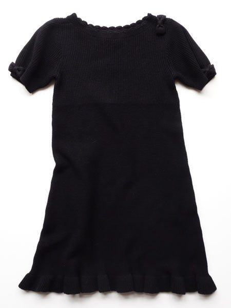 Girls black dress, sweater knit style. Short sleeves with bows, ruffle at hem line, and cute scalloped neckline.