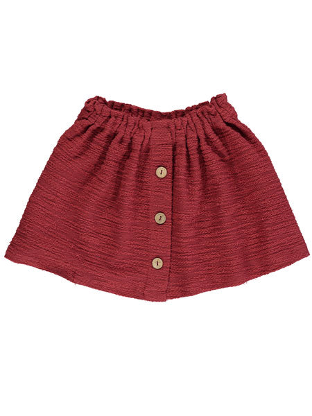 Rust skirt for girls. Gathered elastic waist. Front faux center plaquette with brown button at center.