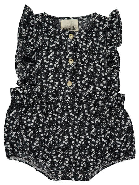 Baby girls bubble style summer romper. Black with small white floral print, ruffle trim over sleeveless opening, and 3 decorative front buttons. The brand is Vignette.