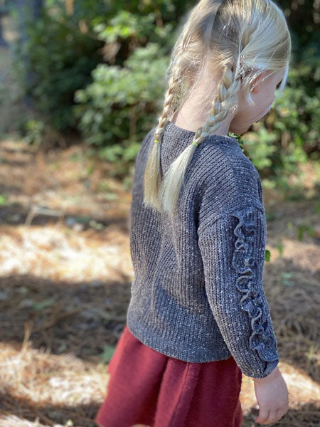Back and side view of  the Jess girls crew neck sweater by Vignette. Heathered charcoal, ruffle detail on sleeve outerside.