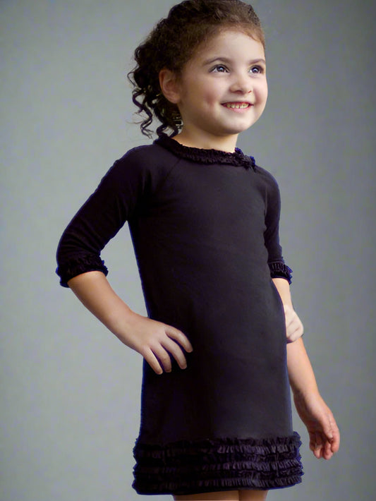 Black medium weight jersey knit dress, long sleeves. Ruffle trim on collar, sleeves, and hem line.